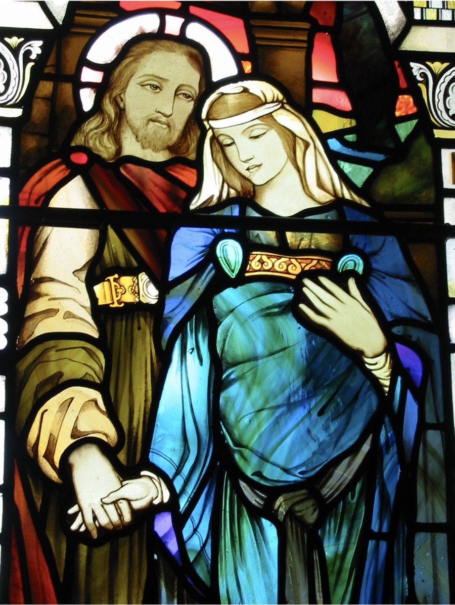 Stained glass window of the Bride and Bridegroom clasping right hands